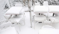 Snow covers chairs and tables of a cafe as winter strikes Vienna, Austria with snow and freezing temperatures on February 20, 2026. (Photo by Joe Klamar / AFP)