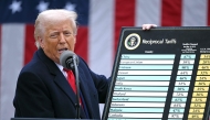 US President Donald Trump holds a chart as he delivers remarks on reciprocal tariffs during an event in the Rose Garden entitled 