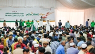 People gather to break their fasts at a tent organised by the Ministry of Awqaf. 