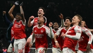 Arsenal celebrate their victory at the end of the English Premier League football match between Tottenham Hotspur and Arsenal at the Tottenham Hotspur Stadium in London, on February 22, 2026. (Photo by Glyn KIRK / AFP)