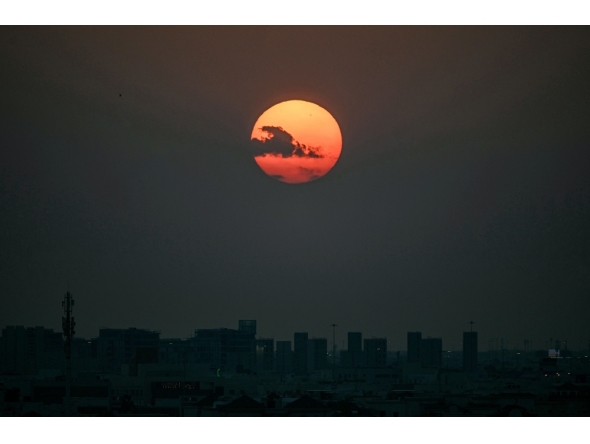 The sun sets over Qatar's capital Doha on February 28, 2026. (Photo by Mahmud Hams / AFP)
 