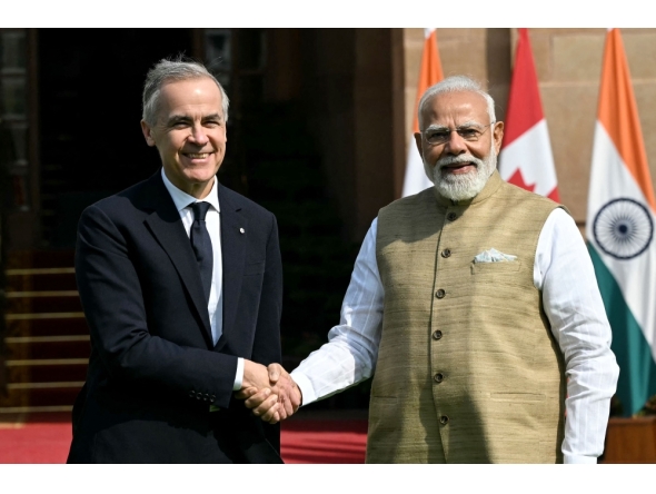 India's Prime Minister Narendra Modi (R) shakes hands with his Canadian counterpart Mark Carney before their meeting at the Hyderabad House in New Delhi on March 2, 2026. (Photo by Sajjad Hussain / AFP)