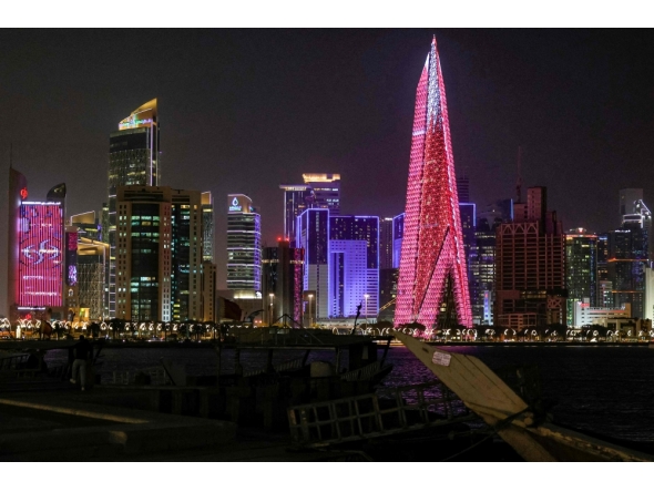 High-rise buildings are pictured at night along the Corniche in Doha on March 1, 2026. (Photo by Karim Jaafar / AFP)