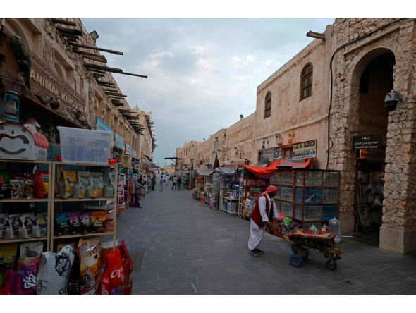 Visitors walk through a bird market at Souq Waqif in Doha on March 4, 2026. Photo by Karim JAAFAR / AFP