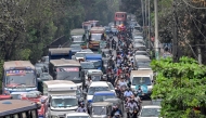 People wait in a queue (R) to refuel their vehicles near a fuel station in Dhaka on March 8, 2026. (Photo by Munir Uz Zaman / AFP)
