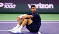 Novak Djokovic of Serbia sits up after falling to the court with exhaustion against Jack Draper of Great Britain in their fourth round match of the BNP Paribas Open at Indian Wells Tennis Garden on March 11, 2026, in Indian Wells, California.  (Photo by CLIVE BRUNSKILL / GETTY IMAGES NORTH AMERICA / Getty Images via AFP)