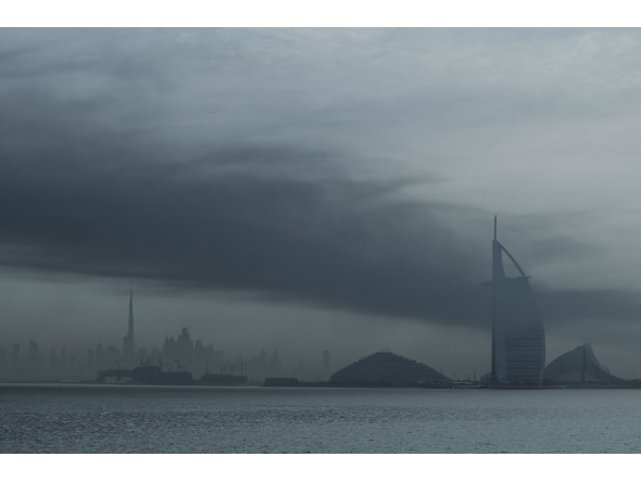 Smoke rises above Dubai on March 13, 2026. Explosions rattled buildings in Dubai and a large cloud of smoke hung over a central area of the Middle East financial hub on March 13, AFP correspondents said. (Photo by AFP) /