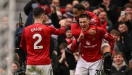 Manchester United's Slovenian striker #30 Benjamin Sesko (R) celebrates with Manchester United's Brazilian striker #10 Matheus Cunha (top R) and teammates after scoring his team's third goal during the English Premier League football match between Manchester United and Aston Villa at Old Trafford in Manchester, north west England, on March 15, 2026. (Photo by Oli SCARFF / AFP)
