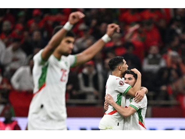 Morocco's forward #10 Brahim Diaz (R) celebrates scoring his team's first goal with Morocco's defender #02 Achraf Hakimi (2nd R) during the Africa Cup of Nations (CAN) quarter-final football match between Cameroon and Morocco at the Prince Moulay Abdallah stadium in Rabat on January 9, 2026. (Photo by Gabriel Bouys / AFP)