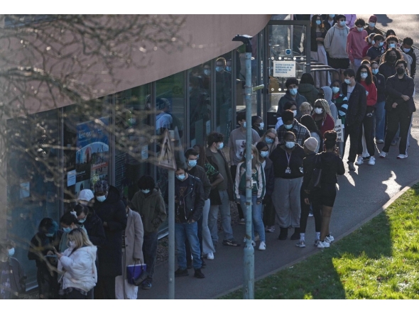 Students wearing face masks queue up to get vaccinated at the University of Kent in Canterbury, south-east England on March 18, 2026, following an outbreak of meningitis. Photo by CARLOS JASSO / AFP