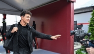 McLaren's British driver Lando Norris arrives to the paddock at the Shanghai International Circuit ahead of the Formula One Chinese Grand Prix in Shanghai on March 12, 2026. (Photo by Hector RETAMAL / AFP)
