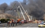 Firefighters spray water to extinguish a fire at a car parts plant in Daejeon on March 20, 2026. (Photo by Yonhap / AFP) 