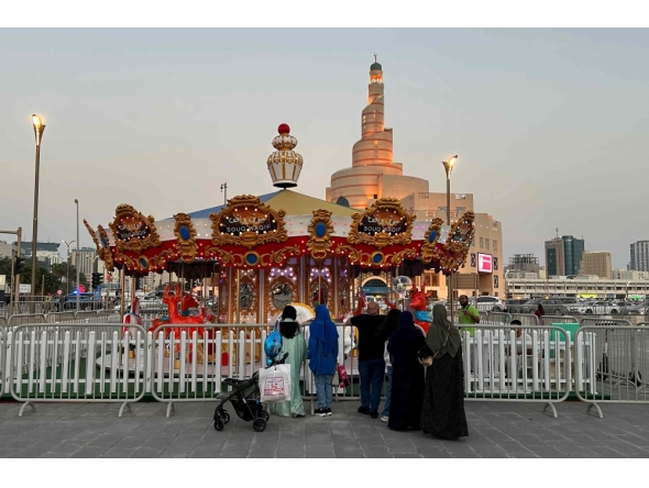 Families mark the second day of Eid al-Fitr at Doha Corniche, Souq Waqif, and Al Masrah park in Qatar. Photos by AFP