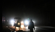 A man walks on a street without electricity during a nation wide blackout in Havana on March 21, 2026. (Photo by Yamil Lage / AFP)