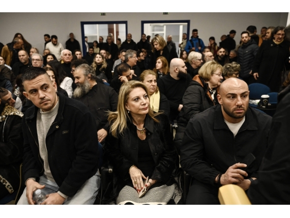 Tempi 2023 Victims' Association president Maria Karystianou (C) sits with relatives inside the 