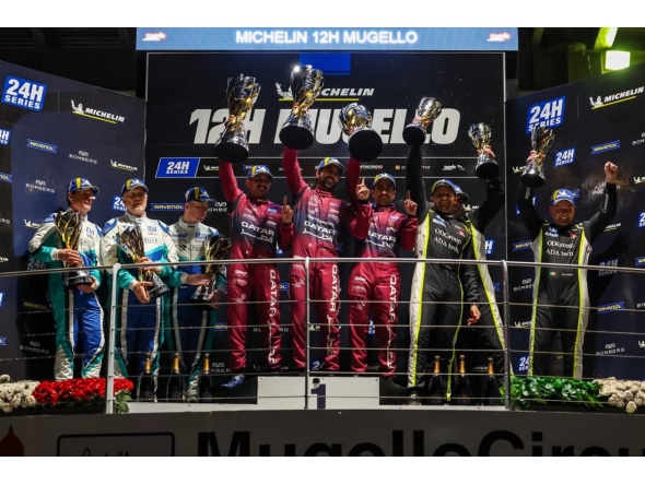 Team Qatar drivers celebrate their victory on the podium.