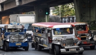 Jeepneys ply their route along a street in Manila on March 23, 2026.Photo by Ted ALJIBE / AFP