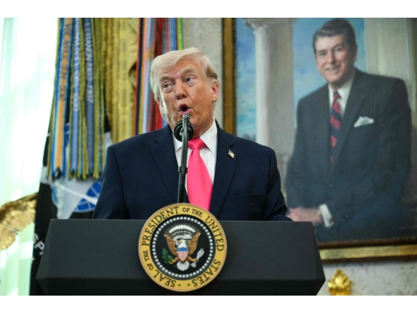 US President Donald Trump speaks before swearing in the new Secretary of Homeland Security Markwayne Mullin in the Oval Office of the White House in Washington, DC, on March 24, 2026. (Photo by Jim WATSON / AFP)
