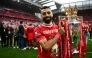 (Files) Liverpool's Egyptian striker #11 Mohamed Salah celebrates with the Premier League trophy on May 25, 2025. (Photo by Paul Ellis / AFP)