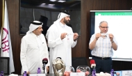 Officials pick teams during the draw ceremony for the 13th Qatar Cup basketball tournament.