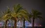 People walk along the Corniche area during a storm over Doha City in Qatar on March 26, 2026. (Photo by Mahmud HAMS / AFP)