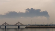 (Files) A plume of smoke rises after a reported Iranian strike on fuel tanks in Muharraq on March 12, 2026. (Photo by Fadhel Madhan / AFP)