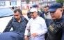 Nepal's former prime minister KP Sharma Oli (C) is escorted by police as he is brought to the hospital following his arrest in Kathmandu on March 28, 2026. (Photo by Prakash Mathema / AFP)