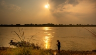 A man fishes along the Mekong River in Vientiane, Laos, March 22, 2026. (Photo by Kaikeo Saiyasane/Xinhua)
