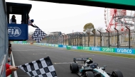 Mercedes' Italian driver Kimi Antonelli crosses the finish line to win the Formula One Japanese Grand Prix at the Suzuka circuit in Suzuka, Mie prefecture on March 29, 2026. (Photo by Franck Robichon / Pool / AFP)