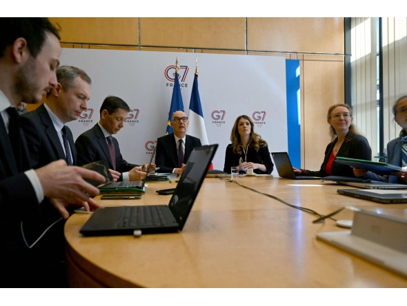 France's Economy and Finance Minister Roland Lescure (C-L) and France's Government Spokesperson and Energy Minister Maud Bregeon (C-R) sit moments before hosting a videoconference with the G7 energy and finance ministers with central banks representatives at the French Economy minister in Paris on March 30, 2026. (Photo by Anna KURTH / AFP)