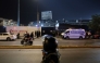 Police officers stand guard at the entrance of the Alejandro Villanueva Stadium while relatives wait for news after an accident in the stands in Lima on April 3, 2026. (Photo by Connie FRANCE / AFP)