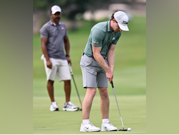 Calum Fitzgerald putts the ball.
