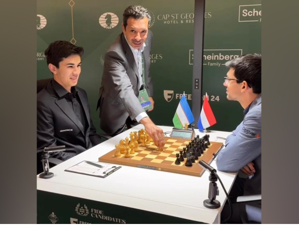 President of the Qatar Chess Federation Mohammed Al-Mudahka makes the ceremonial first move during the match at the Candidates Championship in Cyprus.