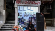This photograph taken on April 4, 2026 shows a shopkeeper selling solar panels awaiting customers at an electrical appliance store in Rawalpindi. (Photo by Farooq Naeem / AFP)