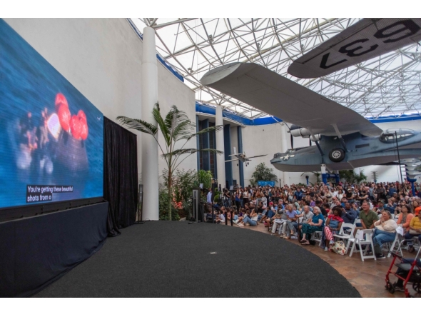 People watch a live broadcast of the return of the Artemis II crew members to Earth at the San Diego Air and Space Museum on April 10, 2026. (Photo by Apu Gomes / AFP)
