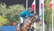 Saudi Arabian rider Abdullah Alsharbatly guides Frenchy Vds over a fence. 