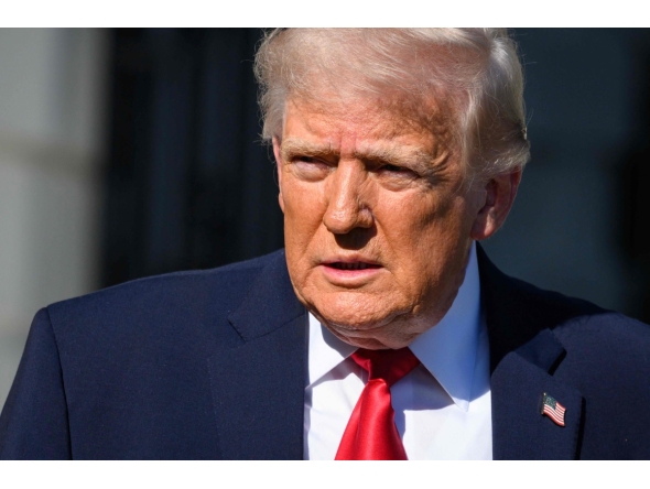 US President Donald Trump walks towards reporters before boarding Marine One to depart from the White House in Washington, DC, on April 11, 2026. (Photo by Mandel NGAN / AFP)