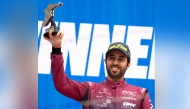Qatari driver Abdulla Al Khelaifi celebrates on the podium after winning the Most Valuable Driver award in the LMGT3 class.