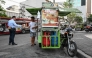 A man sells the popular breakfast roll 'pandesal' in Manila on April 7, 2026. (Photo by Jam Sta Rosa / AFP)