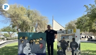Security officer at the National Museum of Qatar, AbduRahman Hussein Khamis holding some of his paintings. Photo by Alexandra Evangelista /The Peninsula