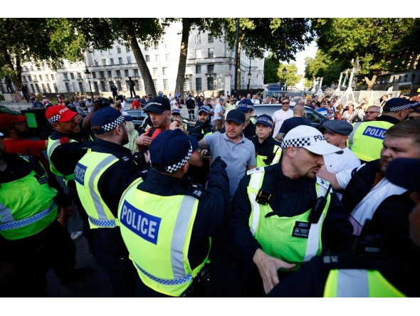 A protestor remonstrates with police officers during the 'Enough is Enough' demonstration on Whitehall, outside the entrance to 10 Downing Street in central London on July 31, 2024, held in reaction the Government's response to the fatal stabbings in Southport on July 29. (Photo by BENJAMIN CREMEL / AFP)