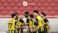 Qatar SC players celebrate a goal against Al Shamal.