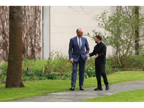 German Chancellor Friedrich Merz and Ukrainian President Volodymyr Zelensky walk in the garden in the backyard of the Chancellery in Berlin on April 14, 2026 (Photo by Odd Andersen/ AFP) 