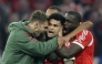 Bayern Munich's Colombian forward #14 Luis Diaz (C) celebrates scoring the 3-3 goal with his teammates during the UEFA Champions League quarter-final second leg football match between FC Bayern Munich and Real Madrid in Munich, southern Germany, on April 15, 2026. (Photo by Alexandra BEIER / AFP)