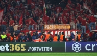 A photographer is treated after fans climbed over the fence after the UEFA Champions League quarter-final second leg football match between FC Bayern Munich and Real Madrid in Munich, southern Germany, on April 15, 2026. Photo by Karl-Josef HILDENBRAND / AFP