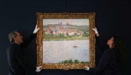 (FILES) Employees of the Sotheby's auction house handle the painting 