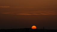 The sun sets over the city of Doha on April 17, 2026. (Photo by AFP)