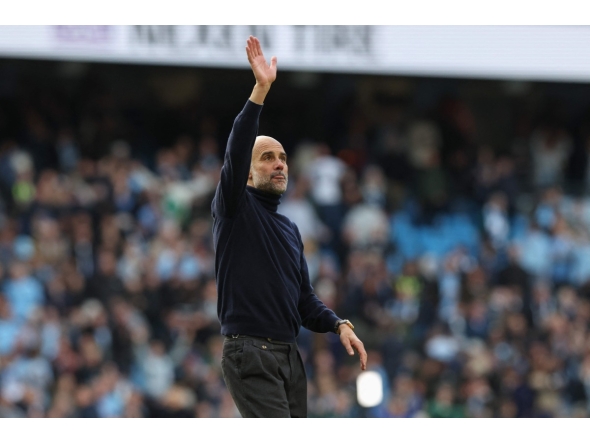 Manchester City's Spanish manager Pep Guardiola waves at the end of the English Premier League football match between Manchester City and Arsenal at the Etihad Stadium in Manchester, north west England, on April 19, 2026. (Photo by Darren Staples / AFP)
