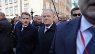 French President Emmanuel Macron (L) and Poland's Prime Minister Donald Tusk walk through Gdansk on April 20, 2026, during Macron's one-day-visit to Poland. (Photo by Ludovic MARIN / AFP)