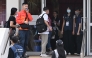 Residents of Wang Fuk Court residential estate arrive to return to their apartments in Hong Kong on April 20, 2026. Photo by Peter PARKS / AFP